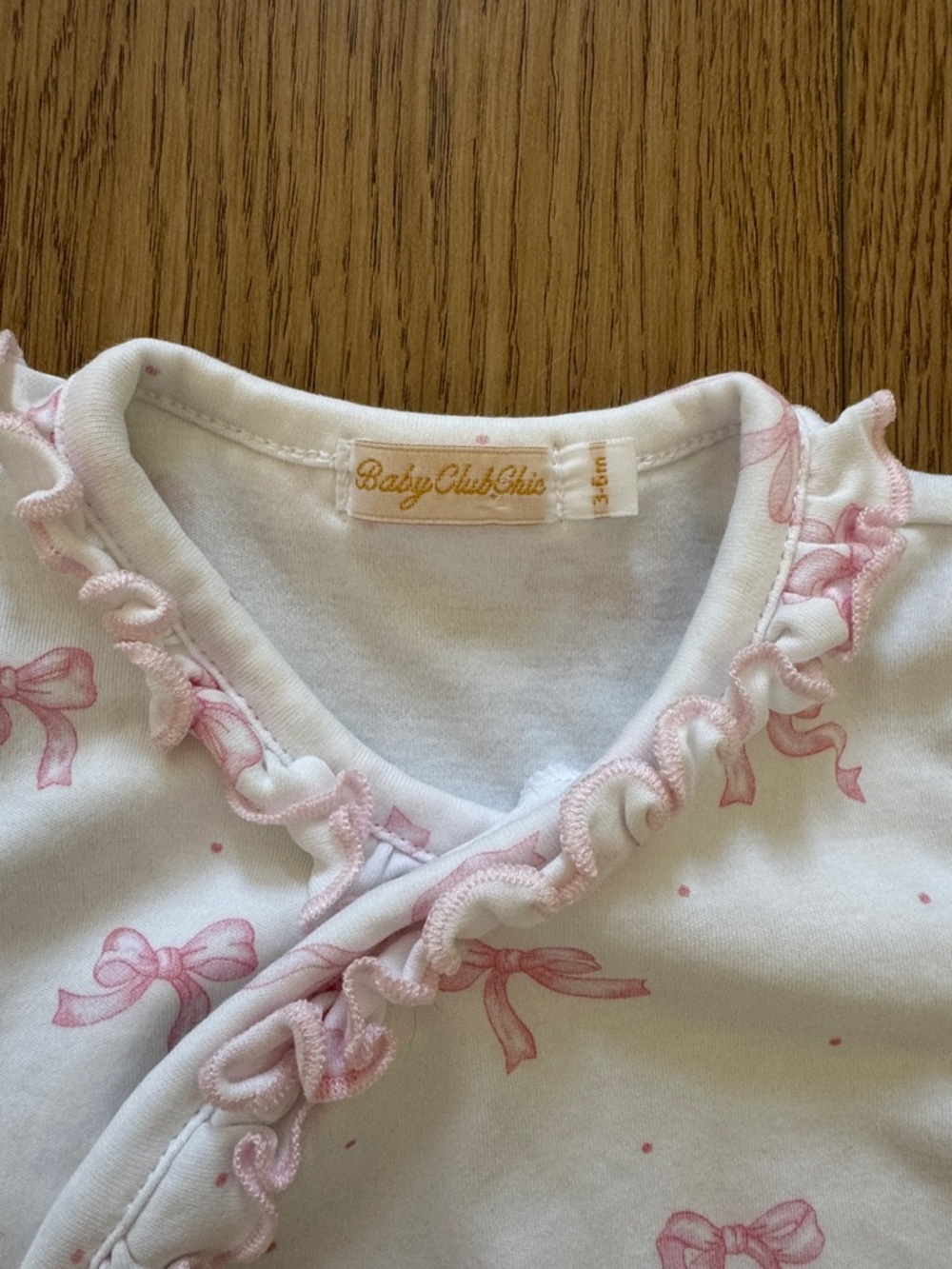 Baby Club Chic One-Piece Footed Sleeper in Pink Bow Print - Picture 2 of 2